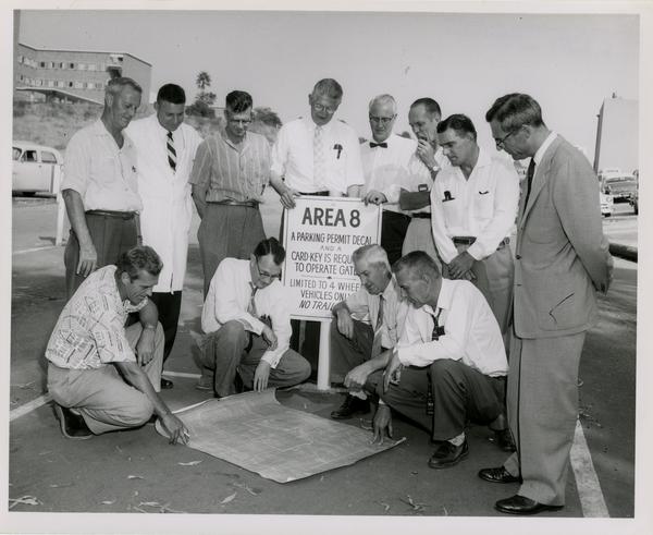 Members of the medical school examine plans of the building as construction comes close to an end, 1959