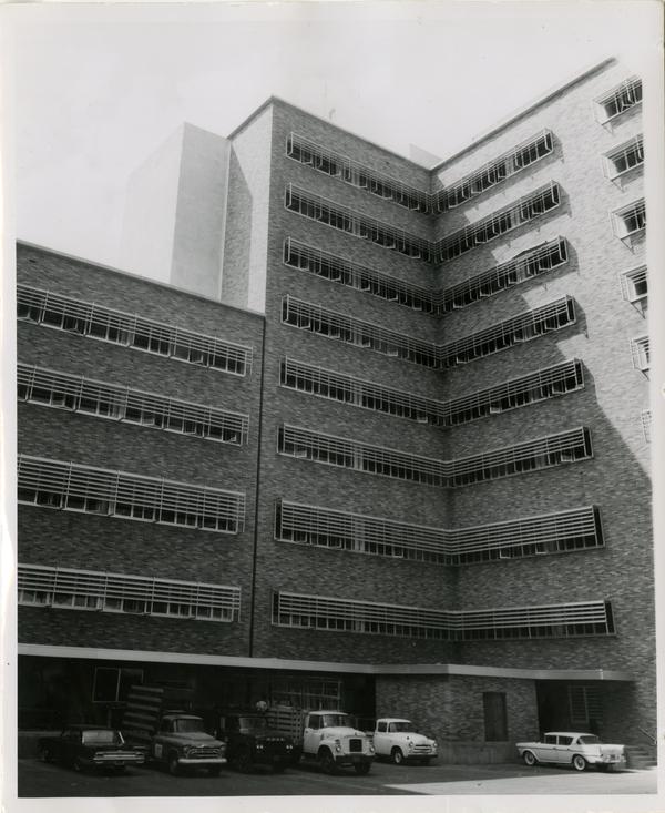 The finished UCLA medical center with work tracks parked in parking spots, 1960