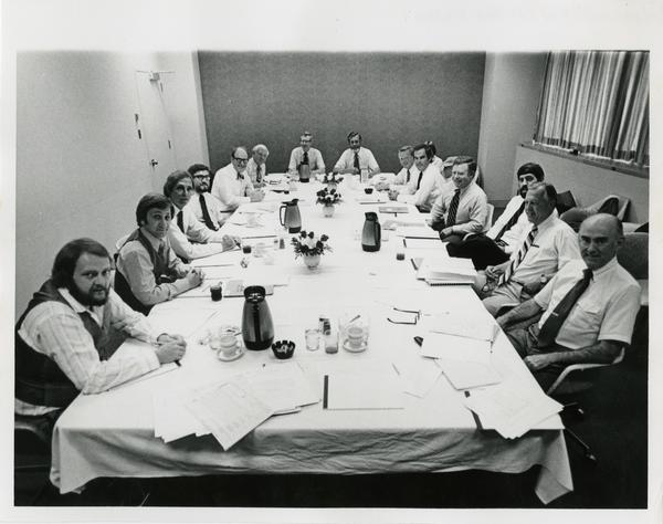 The medical center board of visitors sitting down for a meal, c. 1977