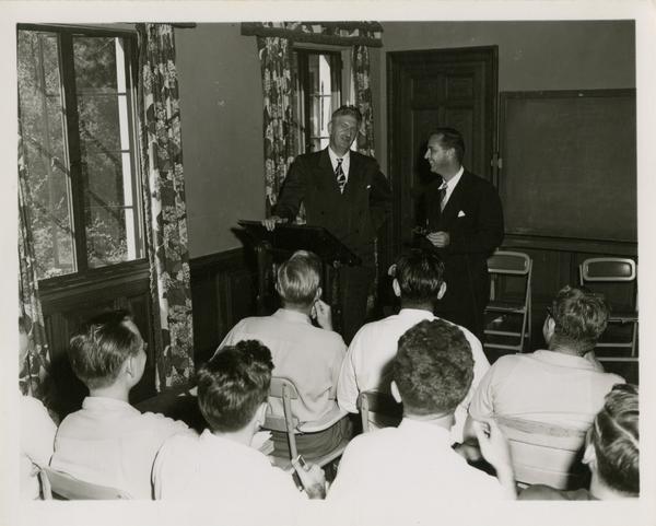 Two men address a crowd of medical school students, 1955