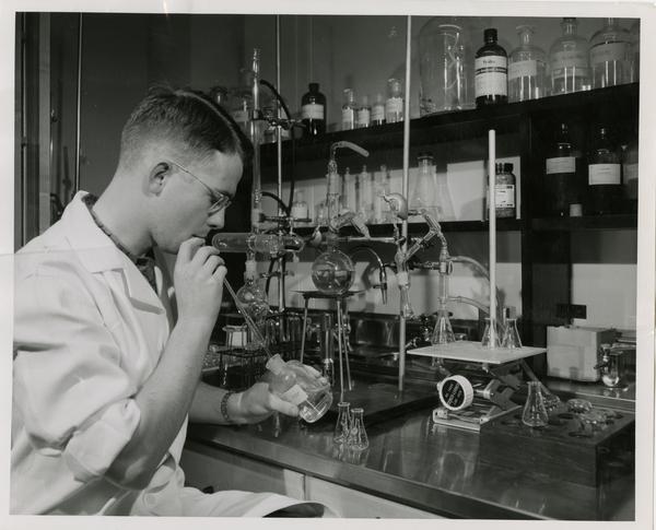 Ove Alfred Nedergaard, research assistant at the Department of Pharmacology sitting at a work station, May 1955