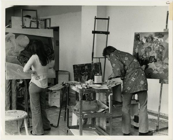 Two students painting in art class circa 1970s