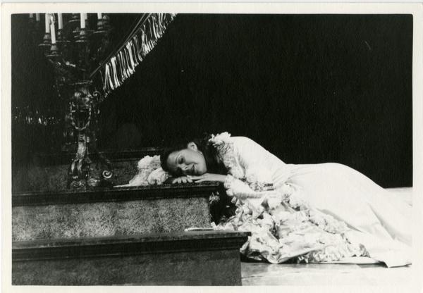 Actress performing a scene on stage during a play