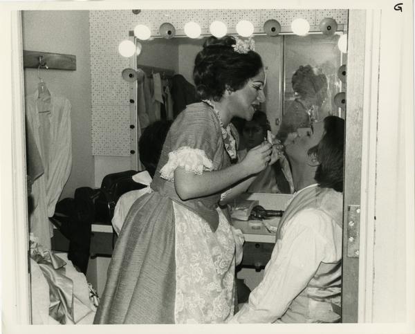 One actress helps an actor with his make up in preparation for Cosi Fan Tutti Opera, 1978