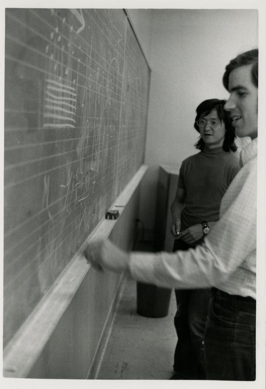 Students writing musical notes at a chalk board for composition class, 1972