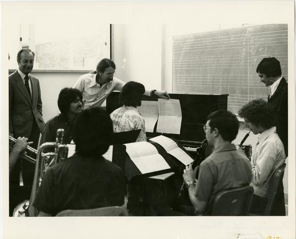 Instructors overlook students playing multiple instruments during composition class, 1975