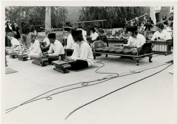 Side view of Javanese Gamelan performers on stage during the Ethno Spring Festival, c. 1970's