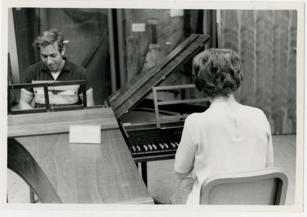 Man and woman playing on separate Harpischords