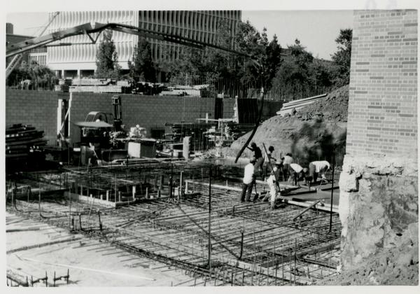 View of Schoenberg Hall construction site with construction workers at work