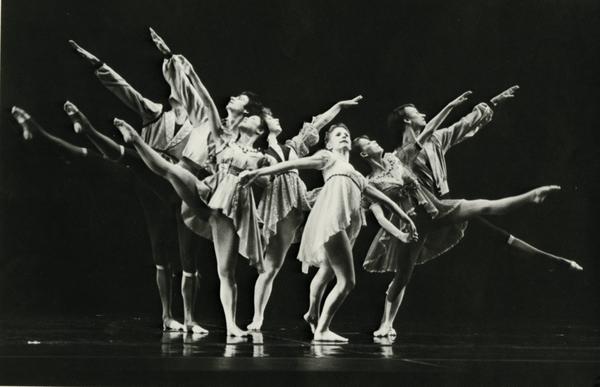 Dancers posing in formation on stage