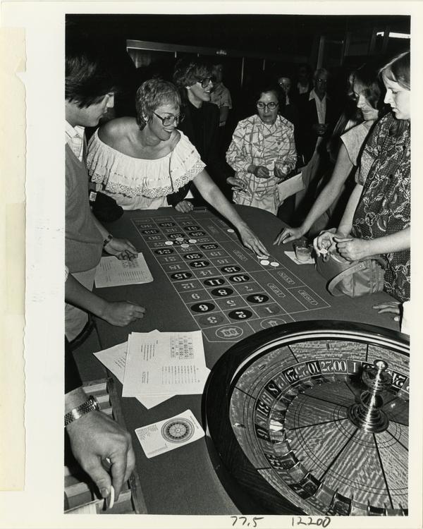 Group playing roulette at Dentistry Casino Night event, 1981