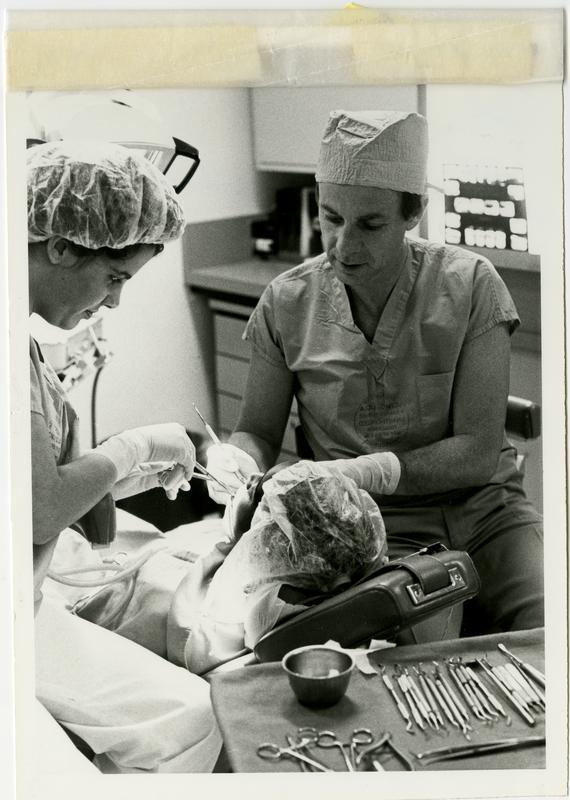 Dr. Barrie Kenney and dental technician working on a patient, 1985