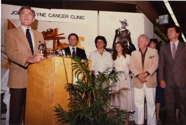 Speaker at podium at opening event for John Wayne Cancer Clinic, 1981