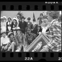 Actors Jodie Foster and Johnny Whitaker presenting painting to Mark Twain Junior High school students in Venice, Calif., 1973