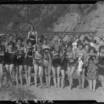 Young women on beach eating watermelon, Pacific Palisades, 1928