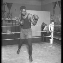 African American Vic Alexander shadow-boxing in ring, circa 1920