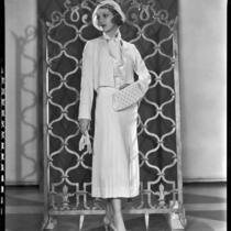 Actress Loretta Young modeling a white ensemble from the Walter Switzer Fashion Salon, 1932