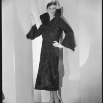 Peggy Hamilton modeling a Hortense hat and a coat with a high collar and flared cuffs, 1931