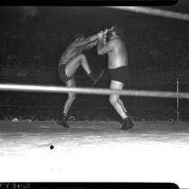 Sandor Szabo and "Big Ben" Morgan wrestle in downtown Los Angeles.  June 30, 1937.