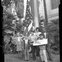 Six children, representing six different races, raising flag to open Los Angeles' Civic Unity Week, 1947