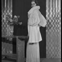 Actress Gail Patrick modeling a white Russian ermine coat, 1933