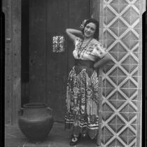 Woman in traditional Mexican dress in front of Hotel Playa de Ensenada, Ensenada, 1931