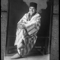 Moor Prince Mohamed Barada sitting with legs crossed, circa 1924