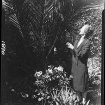 Mary Van Ness Leavitt with palm tree in her garden, Santa Monica, 1928