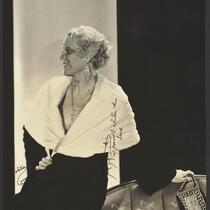 Peggy Hamilton modeling a full length velvet coat with a cape collar in fur, circa 1931-1933