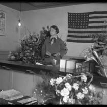 First female Los Angeles Superior Court judge Georgia P. Bullock standing at her bench surrounded by flowers