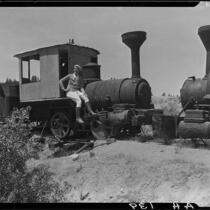 Woman seated on railroad locomotive, Lake Arrowhead, 1929