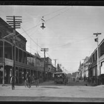 View of Sacramento Street showing streetcar and rows of brick buildings with wooden porticos, Lodi, 1905