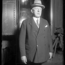 3/4 length portrait of U.S. Steel president James A. Farrell in front of train, circa 1920