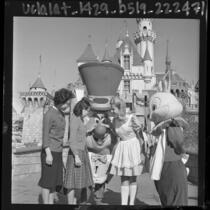 Korean student, Jong Sook Kim, visiting the Mad Hatter and Alice at Disneyland, 1964