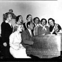 George Gershwin and students singing at the piano, 1937