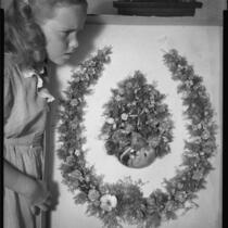 Young girl with horseshoe-shaped wreath of shells made in 1888 by poet Ina Donna Coolbrith, 1953