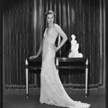 Actress Gail Patrick modeling a beaded evening gown, 1933