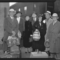 Actor Leo Carrillo, writer Frank Condon, and group near train after return from Mexico, 1936