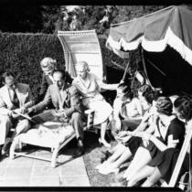 George and Ira Gershwin with students lounging in the sun, 1937