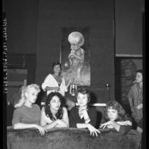 Posing before a sample of beatnik art are Miss Beatnik of 1959 contestants in Venice, Calif.