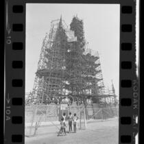 Four girls looking at scaffolding surrounding Watts Towers in Los Angeles, Calif., 1984