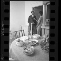 Harriet and Henry Marshall talking as their awaits on table in Los Angeles, Calif., 1968