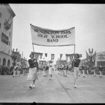 Young women carrying the "Huntington Park High School Band" banner in the Tournament of Roses Parade, Pasadena, 1931