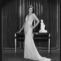 Actress Gail Patrick modeling a beaded evening gown, 1933