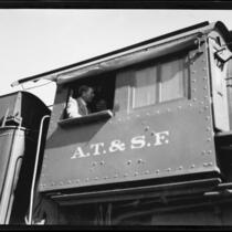 Crown Prince Gustav Adolf of Sweden in the cab, or engineer's compartment, of a train, [Los Angeles?], 1926