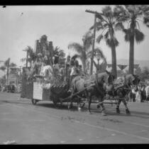 Float with costumed riders and greenery in the parade of the Old Spanish Days Fiesta, Santa Barbara, 1930