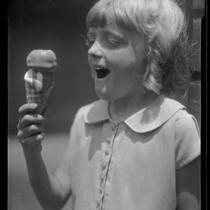 Girl eating an ice cream cone from a concession at Abbot Kinney Pier, Venice, 1928