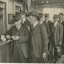 Group of men at ticket counter