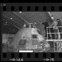 Soviet cosmonaut Georgi T. Beregovoi, astronaut Eugene A. Cernan and others inspecting Apollo 11 capsule at North American Rockwell in Downey, Calif., 1969