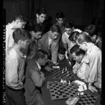 Ray Martin and Arthur Spiller, state champion chess masters playing game, as group of boys watch in Los Angeles, Calif., circa 1953